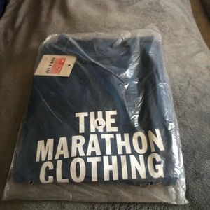 The Marathon Clothing. Brand new with tags Blue T-Shirt in original packaging